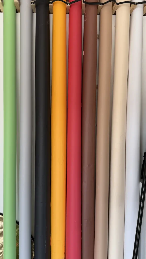 Photography studio paper backdrops in various colours including green, grey, black, yellow, red, brown and beige at Lite Studio