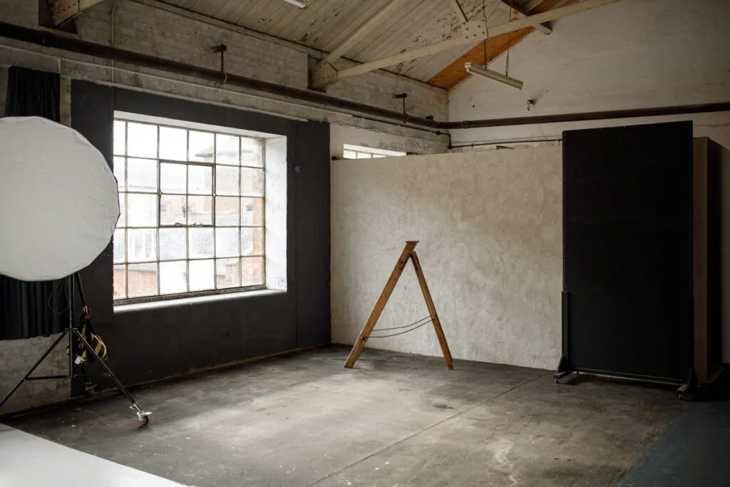 brown textured photography wall with wooden floor