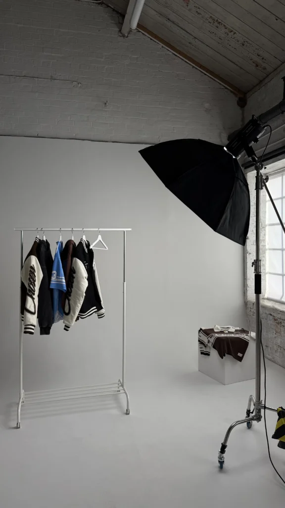 Fashion e-commerce setup with clothing rail and studio lighting on the white cyclorama