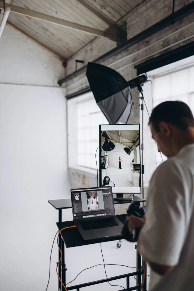 Photographer reviewing images during a tethered portrait session at Lite Studio