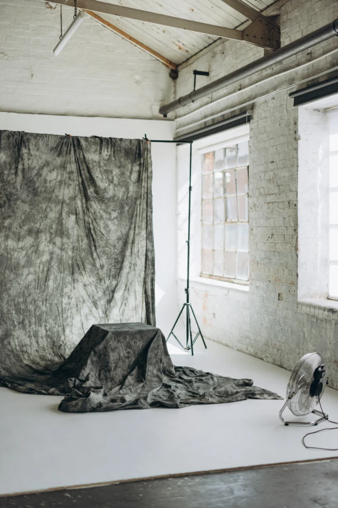 Textured grey photography backdrop set with natural window light at Lite Studio