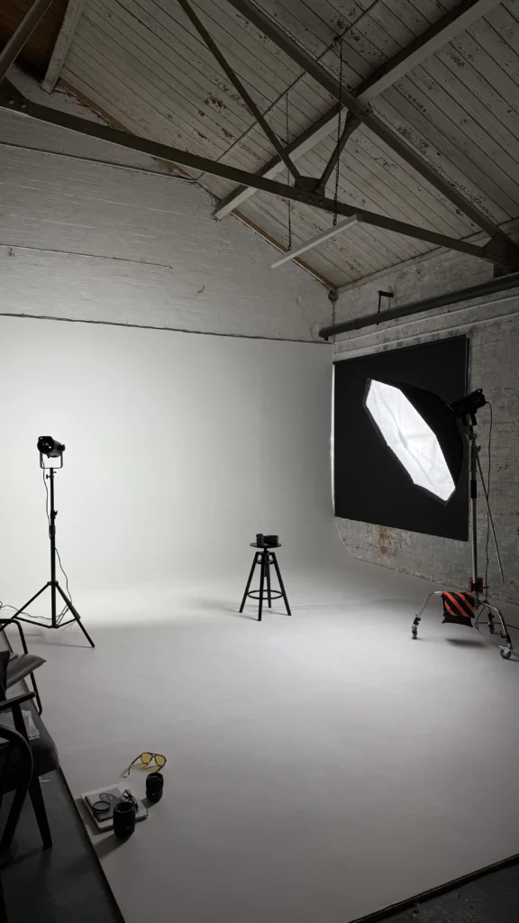 White cyclorama prepared with professional lighting for a commercial photoshoot
